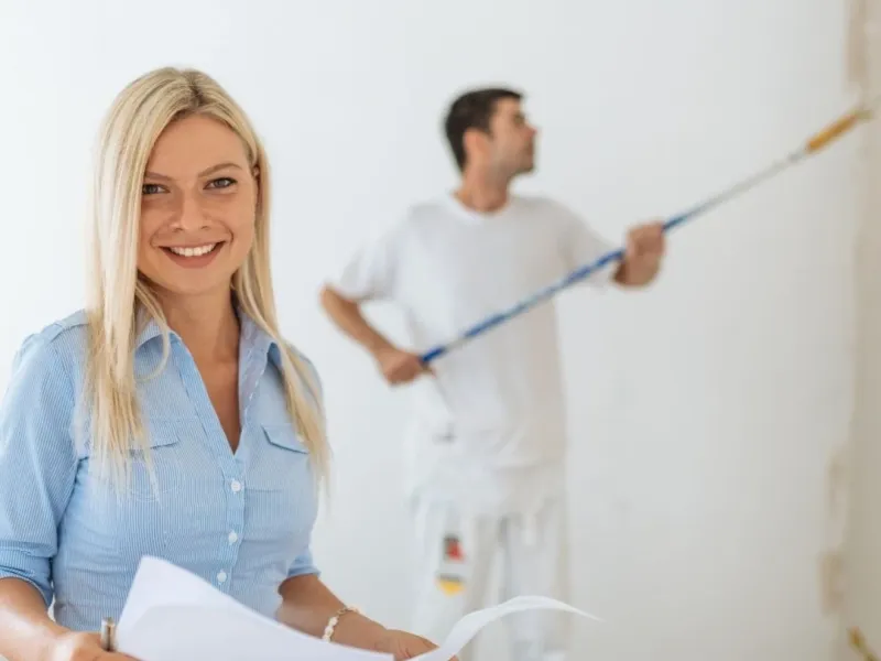 Project manager coordinating an Olive Branch MS unit turn while painter rolls walls