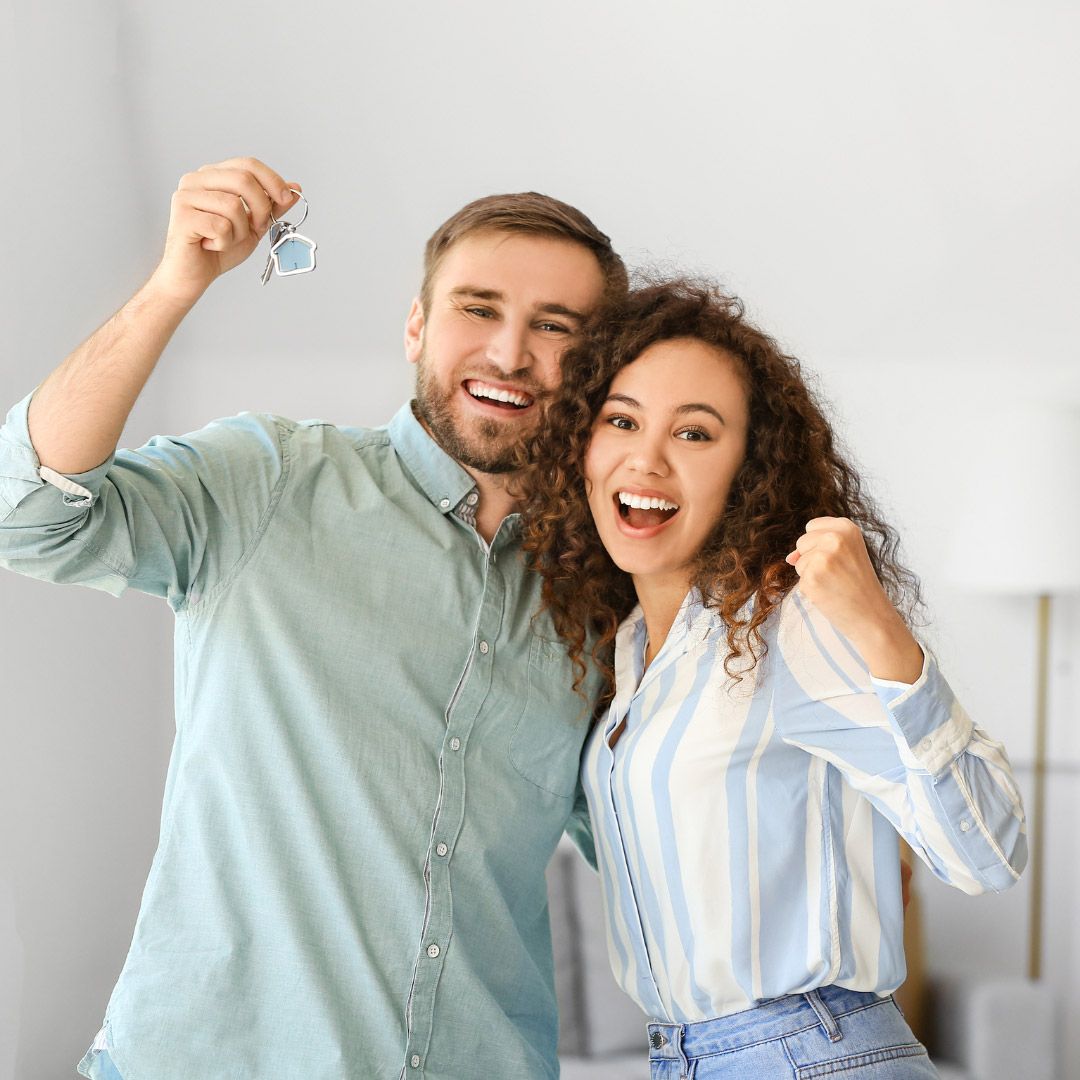 Two people cheering in their home.