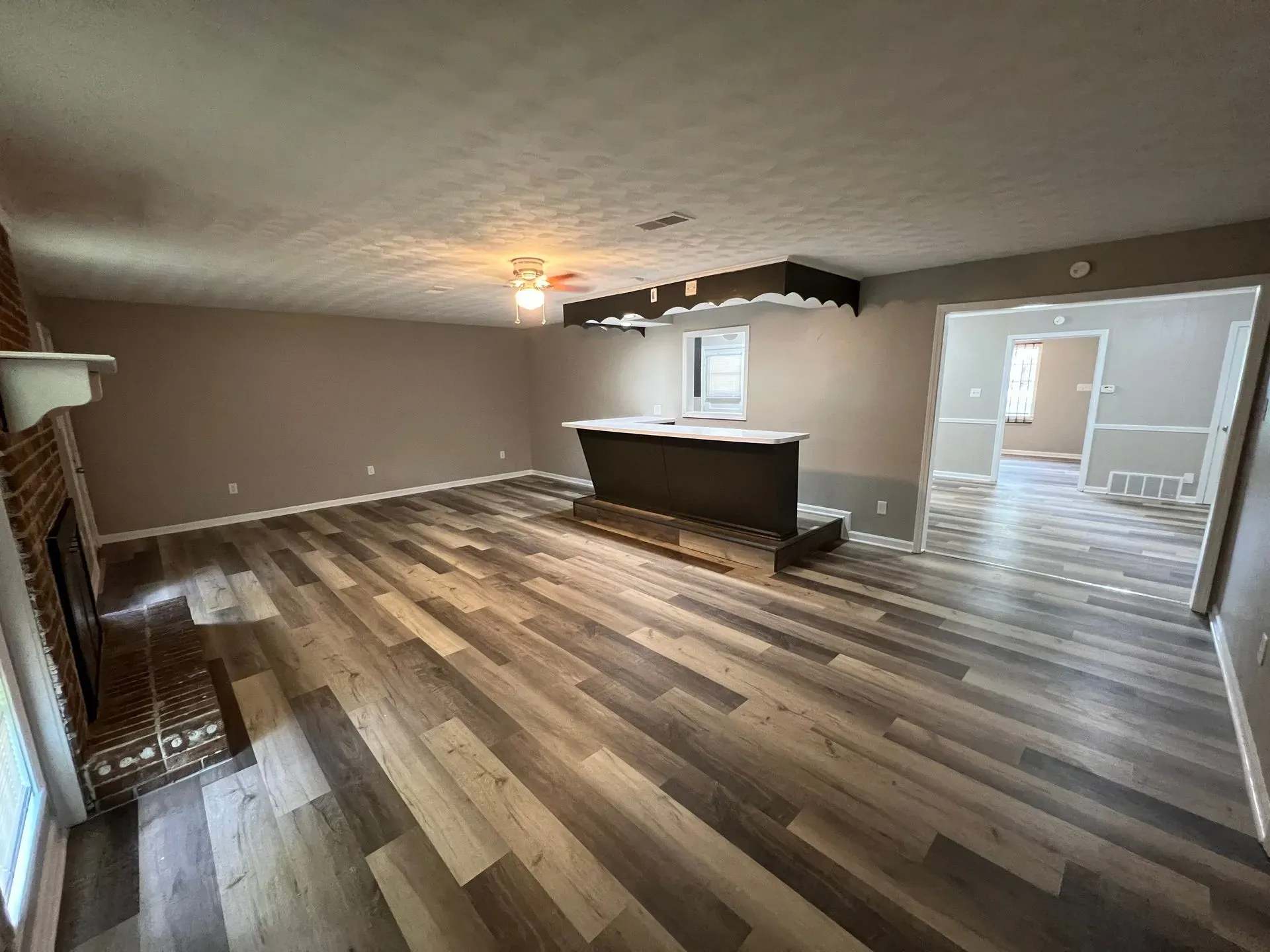 A wide angle view of the new floor and painted living room after renovation.