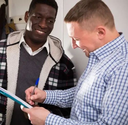 Property manager reviewing lease paperwork with tenant for Section 8 property management in Nesbit, MS