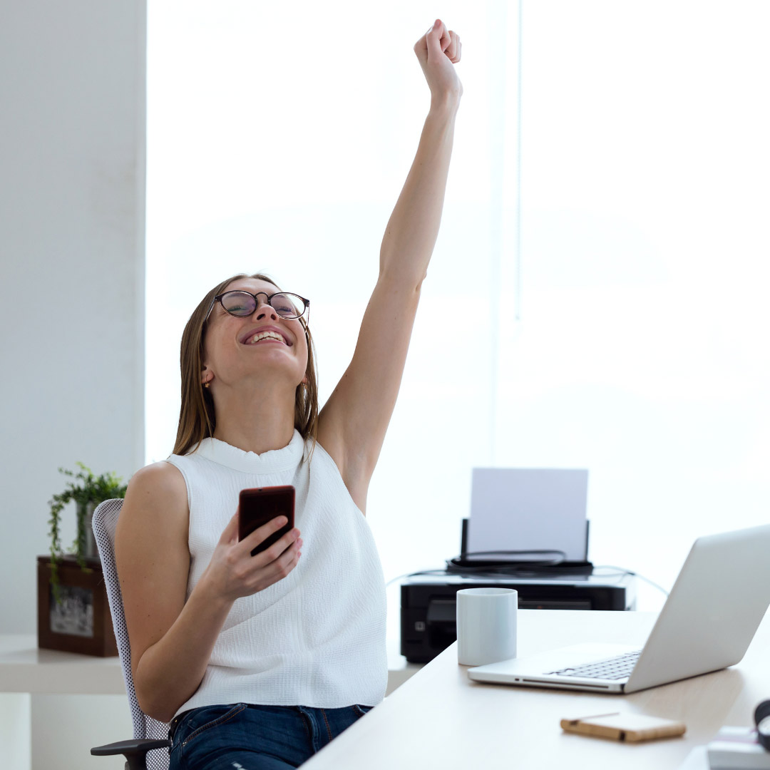 Person cheering at their desk. Property Management in Germantown, TN