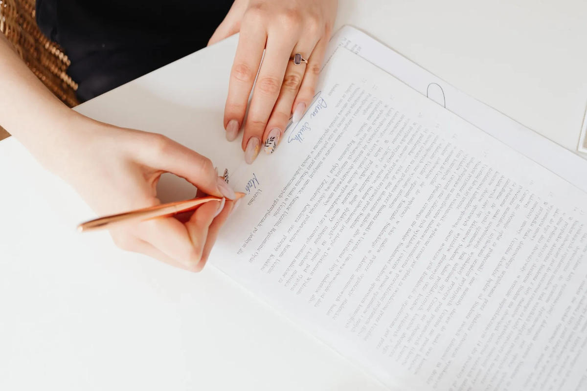 A person signing a contract - property management in Arlington TN