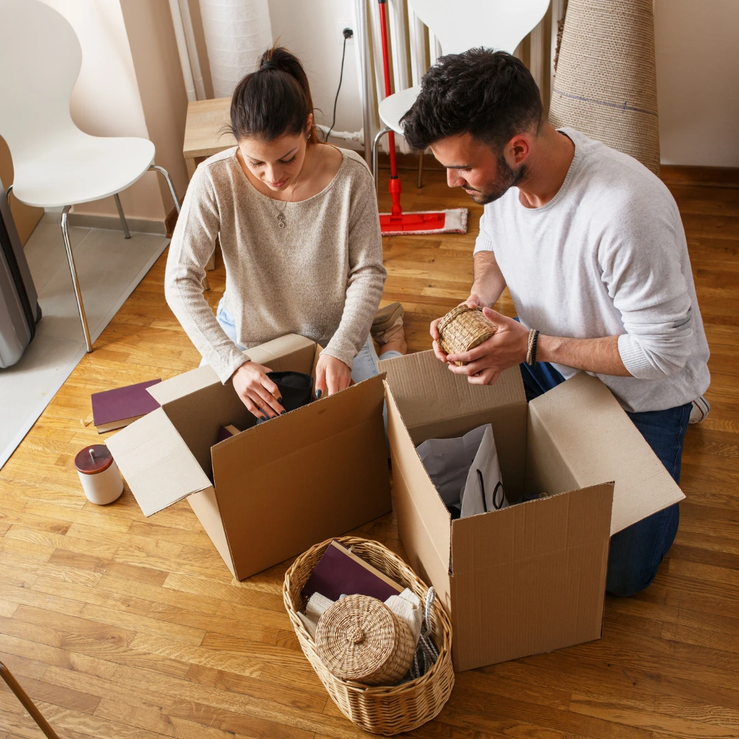 People unpacking moving boxes. Property Management in Eads, TN
