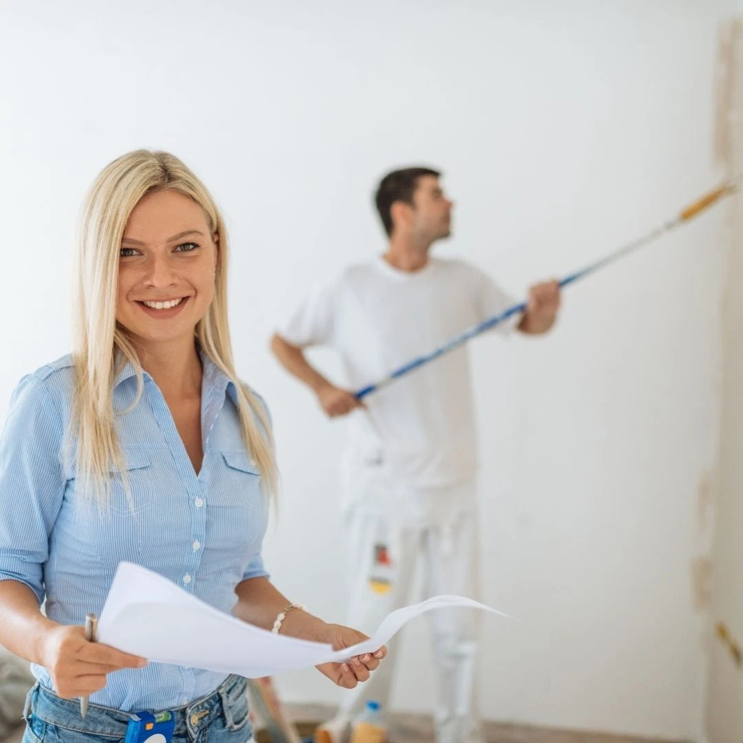 Project manager coordinating an Olive Branch MS unit turn while painter rolls walls