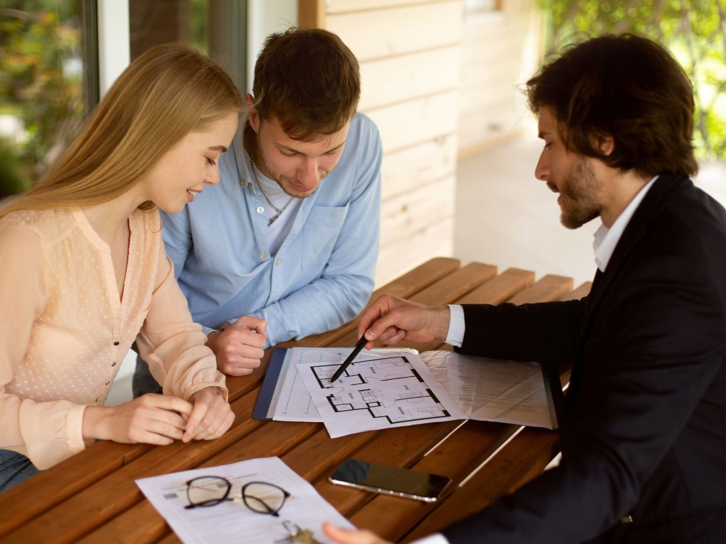 Project manager reviewing renovation floor plan with Lakeland owners during scope and budget meeting.
