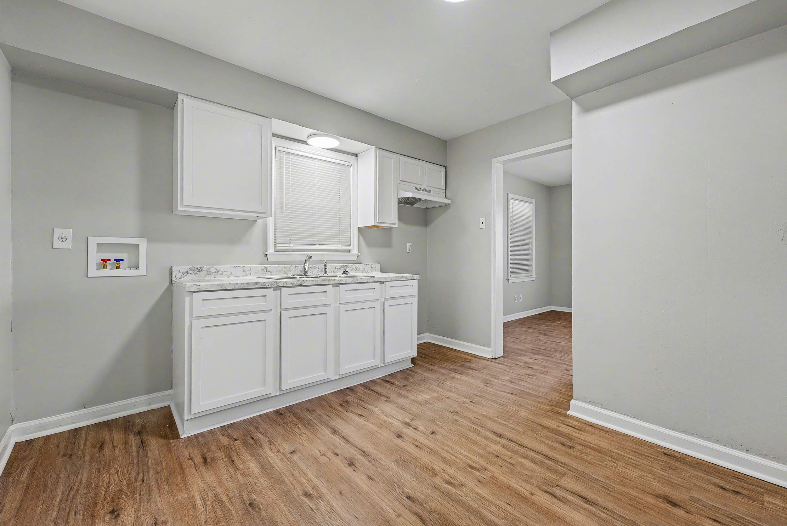 Completely renovated kitchen with white cabinets and countertops.