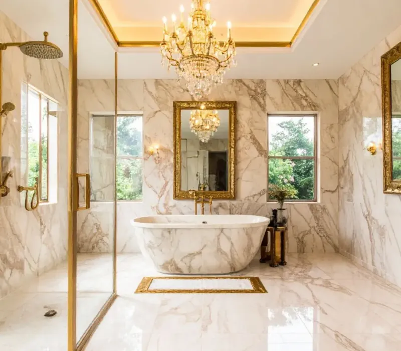 Luxury bathroom renovation with marble tile, glass shower, freestanding tub, and upgraded lighting for property management renovation in Byhalia, MS.