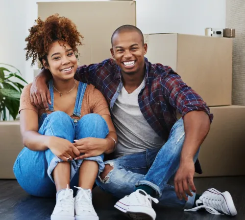 Couple in front of moving boxes.