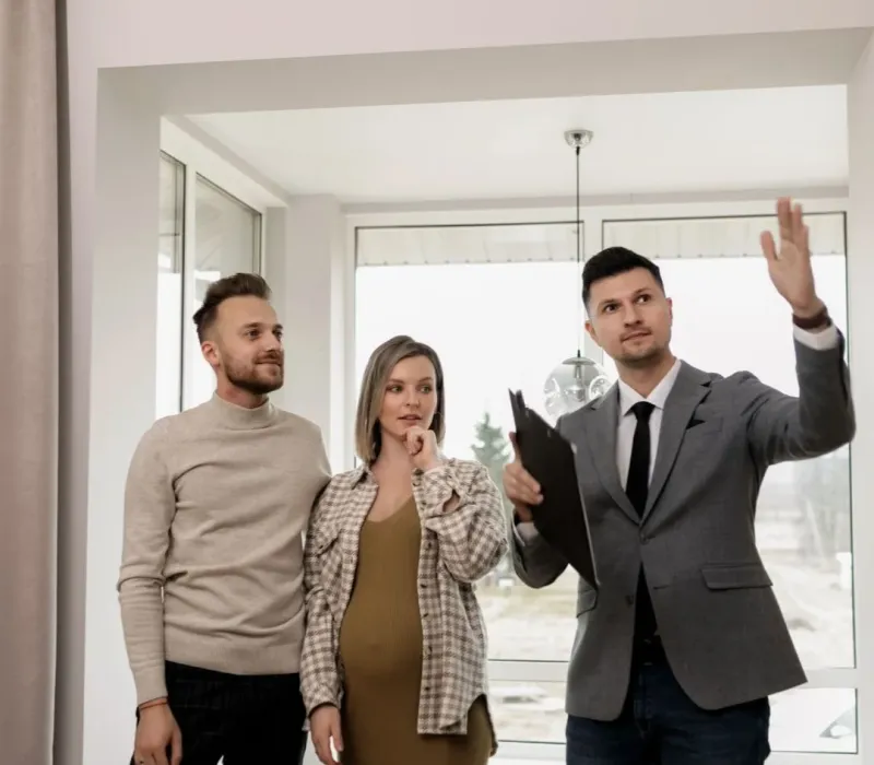 Real estate agent walking buyers through a home during BRRRR acquisition support in Arlington, TN