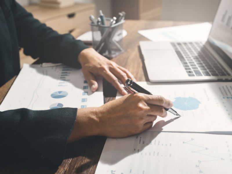 Hickory Hill Memphis BRRRR investment planning with hands reviewing documents, pen in hand, and a calculator on the desk