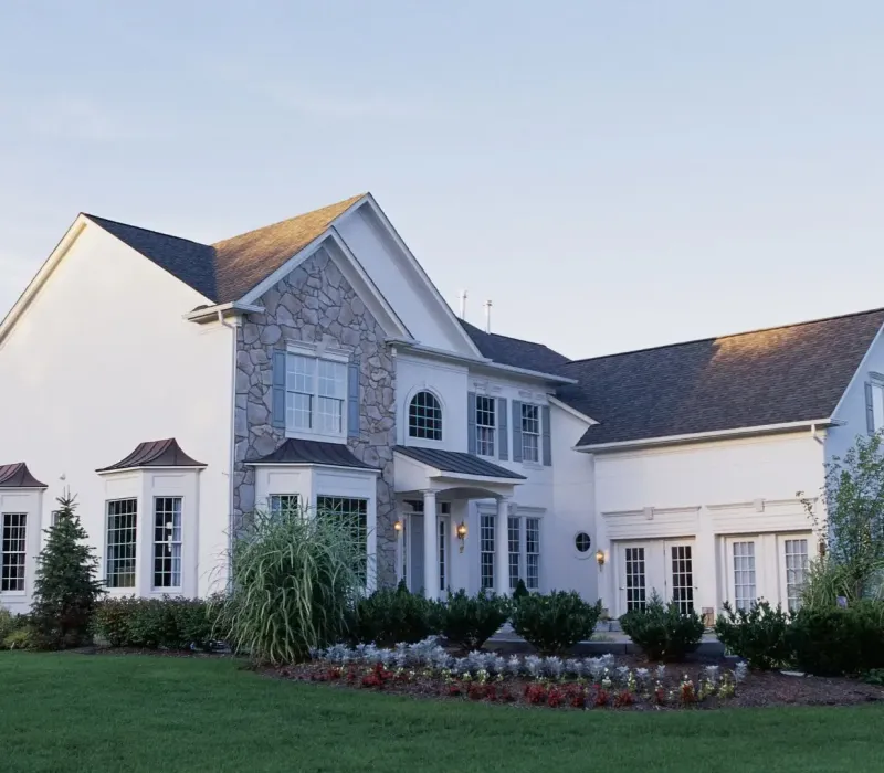 Updated rental home exterior with stone facade, clean landscaping, and attached garage in Piperton, TN