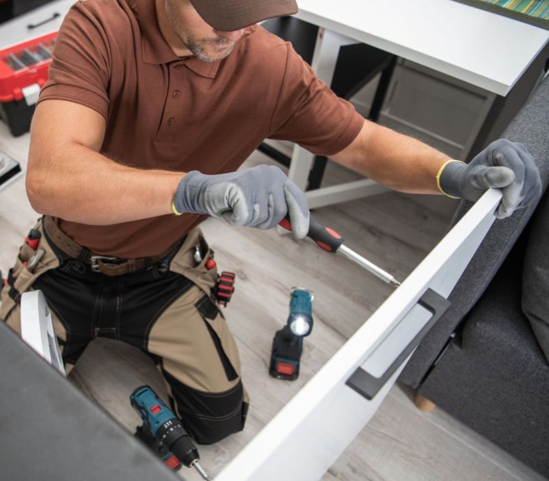 Maintenance technician repairing a drawer with tools during a rental renovation project in Piperton, TN