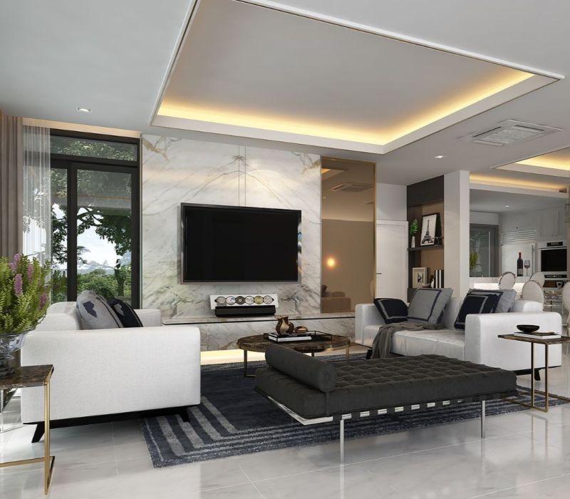 Renovated living room in Lakeland TN with recessed lighting, marble feature wall, and modern staging.