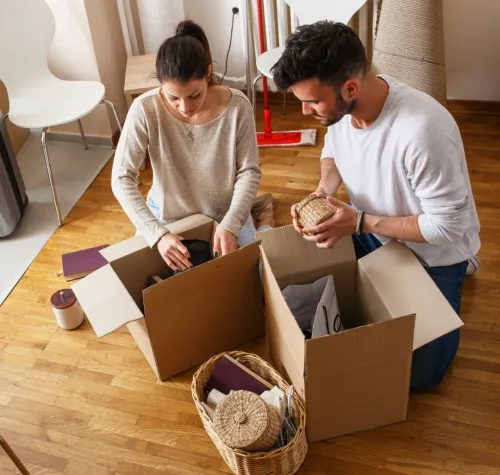People unpacking moving boxes. Property Management in Eads, TN