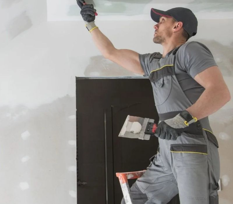 Contractor patching and smoothing drywall during a rental renovation in Germantown, TN.