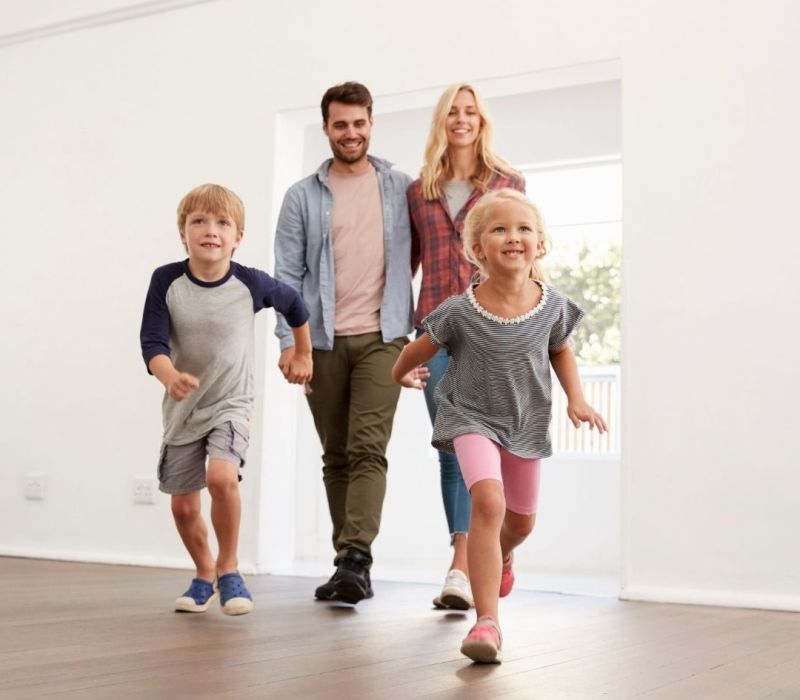 Happy family with two kids walking into a freshly renovated rental home in Horn Lake MS.