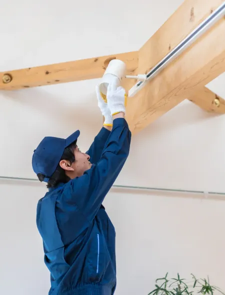 Maintenance technician installing a light fixture during property maintenance in a Horn Lake, MS rental