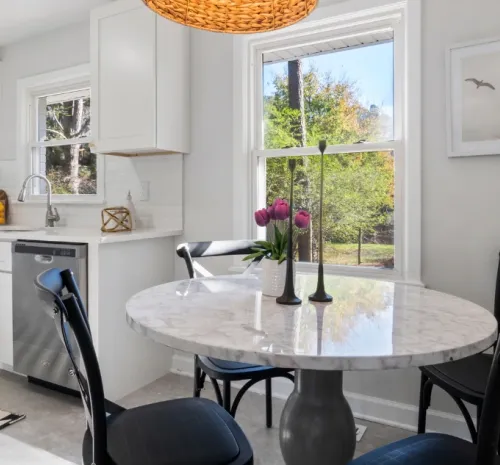 Cozy candle on a desk. Couple holding a set of house keys. Property management in Millington, TN