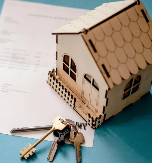 Model house and keys on a signed lease for a managed rental home in Hernando, MS