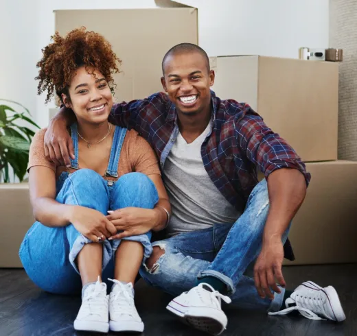 Couple in front of moving boxes.