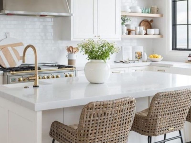 Updated white kitchen in a Cordova, TN rental with quartz island, brass fixtures, and open shelves
