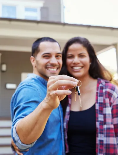 Couple holding a set of house keys. Property management in Millington, TN