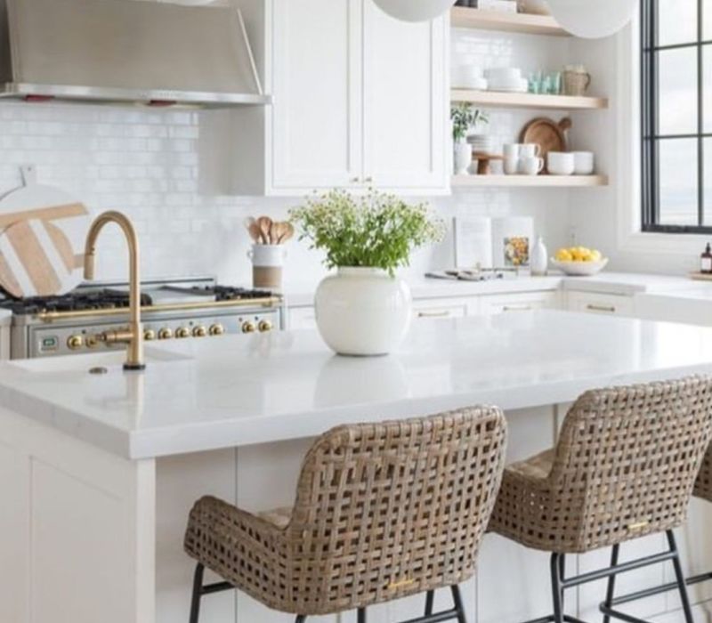 Updated white kitchen in a Cordova, TN rental with quartz island, brass fixtures, and open shelves