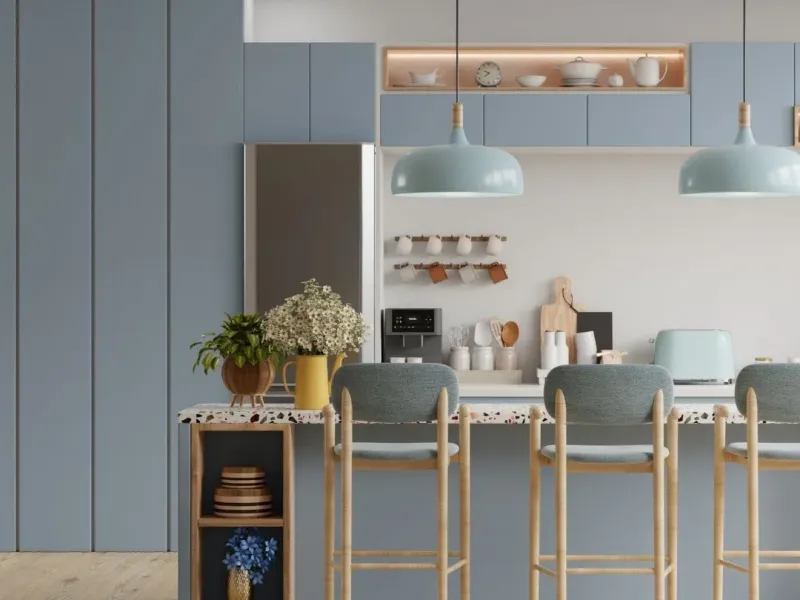 Modern kitchen renovation in Memphis, TN with blue cabinets, island seating, and pendant lighting.