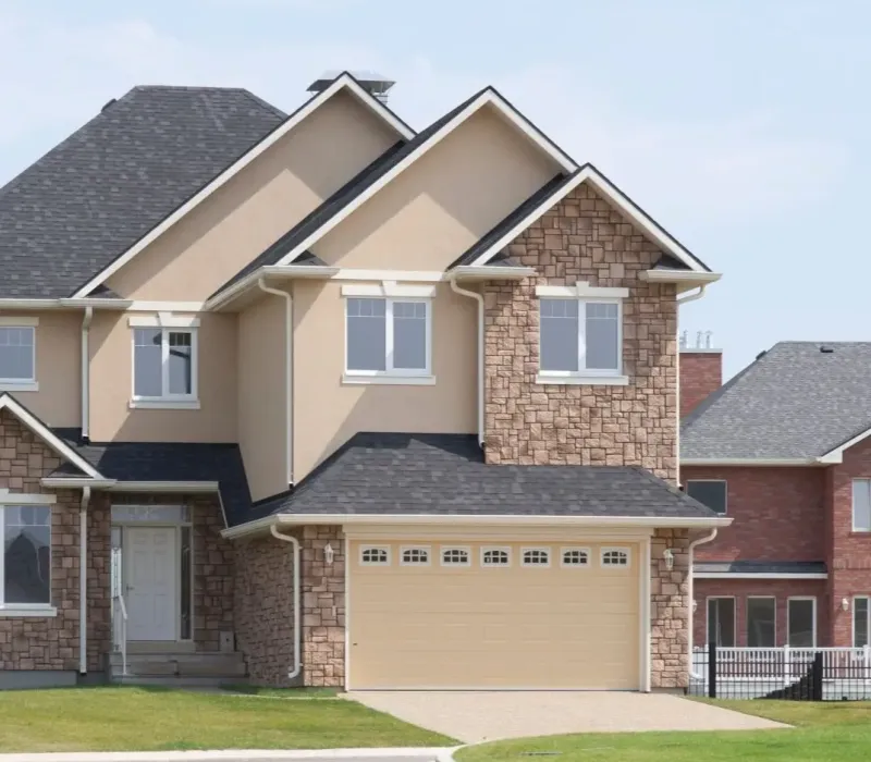 Two-story suburban brick home with a two-car garage and front lawn, Self-Managing Rental Property in Collierville