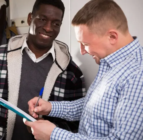 Property manager reviewing lease paperwork with tenant for Section 8 property management in Nesbit, MS