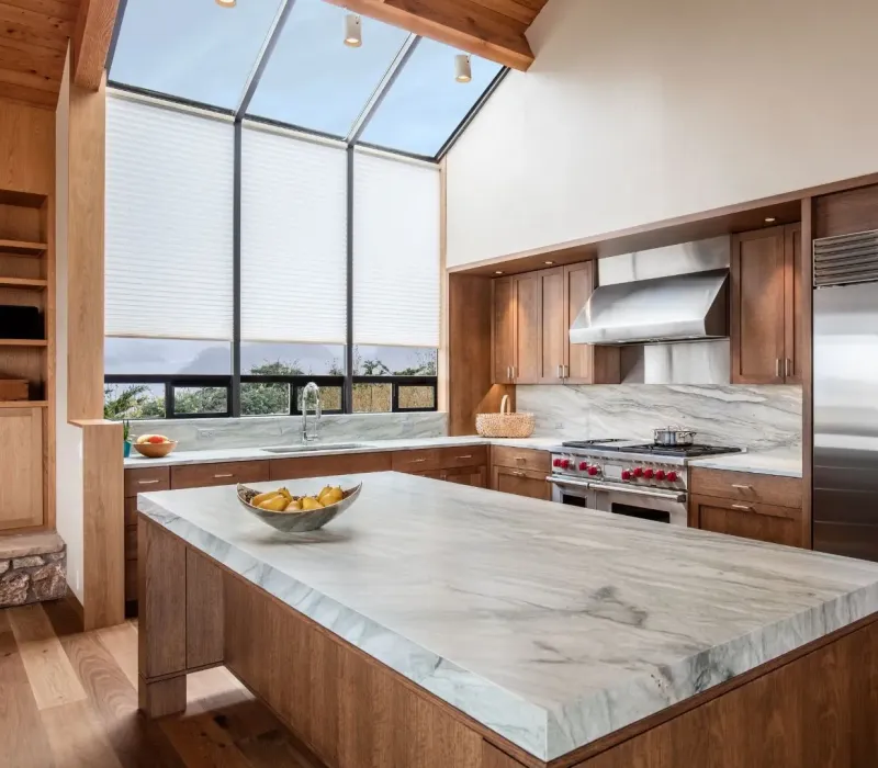 Renovated Nesbit MS rental kitchen with marble island, wood cabinets, and stainless appliances.